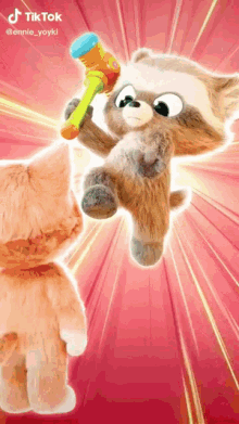 a stuffed animal is holding a hammer and another stuffed animal is jumping in the air