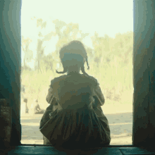 Looking Outside The Underground Railroad GIF - Looking Outside The Underground Railroad Sitting Alone GIFs