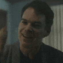 a close up of a man 's face with his eyes closed in a room .
