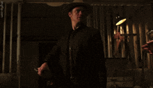 a man in a cowboy hat talks to another man