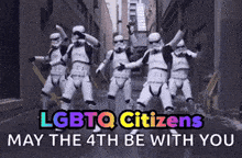a group of stormtroopers are dancing in an alleyway with the words " lgbtq citizens may the 4th be with you "