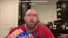 a bald man is holding a bag of m & m 's chips