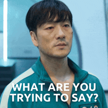 a man in a green jacket with the words what are you trying to say below him