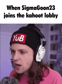 a man wearing headphones and a beanie with a yub patch on it .