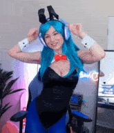 a woman in a bunny costume is wearing headphones and a red bow tie