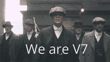 a group of men are standing in a line with the words we are v7