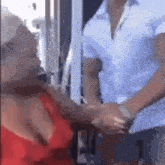 a man and a woman are shaking hands in a room .