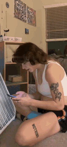 a woman with a tattoo on her leg that says " not thing "