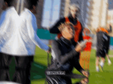 a blurry picture of people on a field with the watermark @justaidan