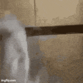 a close up of a person holding a knife in a bathroom .