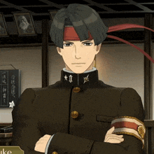 a man with his arms crossed has a red headband with the letter ii on it