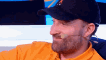a man with a beard wearing a black hat that says ' nfl ' on it