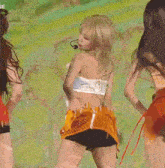 a group of women are dancing on a stage in front of a screen .