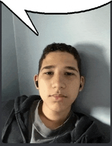 a young man wearing headphones and a hoodie is laying down with a speech bubble above his head .