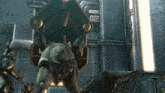 a man in a video game is standing in front of a door that says ' ii ' on it
