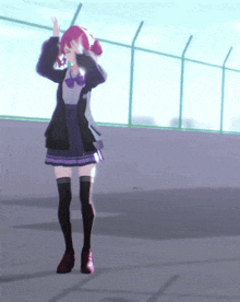 a girl with red hair is standing in front of a green fence