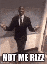 a man in a suit and tie is dancing with his arms outstretched and the words `` not me rizz '' .