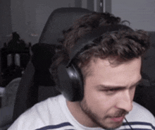 a man wearing headphones and a striped shirt