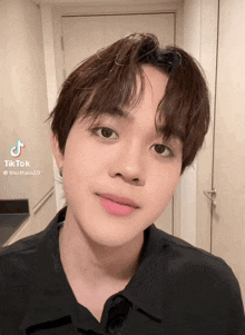a close up of a young man 's face with a tiktok watermark