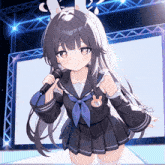 a girl with bunny ears holds a microphone in her hand