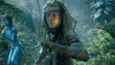 a movie poster for avatar shows a man with dreadlocks and a woman in a blue suit