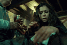 a woman with a ring on her finger looks at a bloody hand