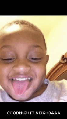 a young boy is sticking his tongue out and says goodnight neighbor