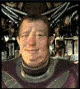 a man in a purple suit is smiling with his eyes closed