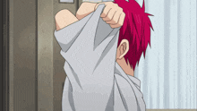 a person with red hair taking off their shirt