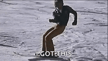 a man is riding a snowboard down a snow covered slope .
