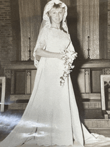 a black and white photo of a bride in her wedding dress