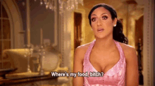 a woman in a pink dress is standing in a room and asking where 's my food , bitch ?