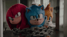 sonic knuckles and tails are chained together