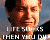 a man is crying with the words life sucks then you die on his face