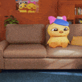 a cartoon duck is sitting on a couch in front of a picture of two ducks