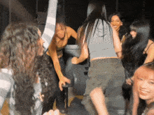 a group of women are dancing in a club