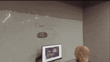a man sits at a desk in front of a white board that says daniel 2 : 5