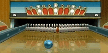 a bowling alley with a row of pins and a blue ball