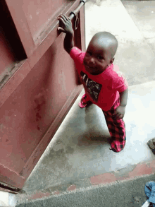 a baby wearing a red shirt that says ' i love you '