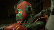 a robot with red eyes and a green head