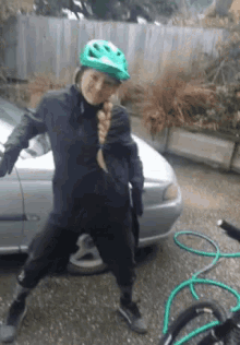 a person wearing a green helmet is standing next to a hose