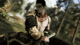 a man in a black and gold outfit is holding a sword in a video game
