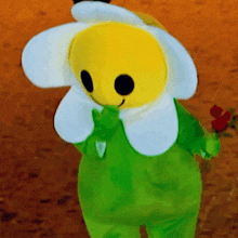 a stuffed flower with a yellow face and white petals