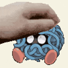 a hand is petting a cartoon character that looks like a spaghetti monster