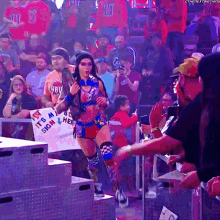 a woman holding a sign that says " it 's my sign "