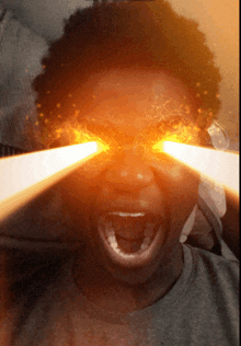 a close up of a person 's face with fire coming out of the eyes