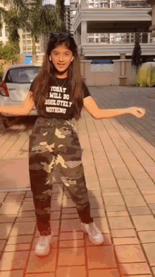 a girl wearing a t-shirt that says today i can do absolutely nothing is dancing