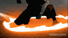 a video of a person jumping over a fire with the website clideo.com in the lower right corner