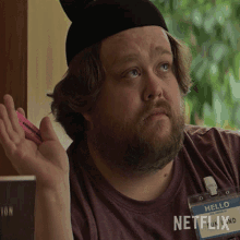 a man with a name tag that says netflix on it