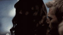 a close up of a woman looking at a man
